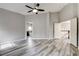 Spacious bedroom featuring wood floors, doors to bathroom and hallway, and a ceiling fan at 313 Vista Glen St, Las Vegas, NV 89145