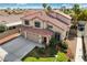 Two-story home features a red tile roof, three-car garage, mature landscaping, and fresh green lawn at 313 Vista Glen St, Las Vegas, NV 89145