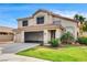 Charming two-story home with a tile roof, spacious three-car garage, and well-manicured front lawn at 313 Vista Glen St, Las Vegas, NV 89145