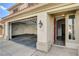 Home featuring a three-car garage and an open front door at 313 Vista Glen St, Las Vegas, NV 89145