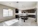 Modern kitchen boasts dark cabinets, granite countertops, an island, and abundant natural light at 313 Vista Glen St, Las Vegas, NV 89145