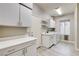 Practical laundry room featuring white cabinets, sink, washer, and dryer at 313 Vista Glen St, Las Vegas, NV 89145