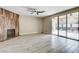 Spacious living room with a fireplace, wood look flooring, and sliding glass doors leading to the pool at 313 Vista Glen St, Las Vegas, NV 89145