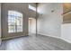 Living room featuring wood look flooring, tall ceilings, lots of natural light, and neutral paint colors at 313 Vista Glen St, Las Vegas, NV 89145