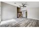 Open living room with high ceilings, gray wood floors, and a ceiling fan fixture at 313 Vista Glen St, Las Vegas, NV 89145