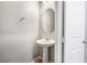 Half bathroom features pedestal sink, oval mirror, and tile floors at 3188 Via Da Vinci, Henderson, NV 89044