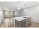 Kitchen island with stainless steel dishwasher and stone countertop overlooking living area at 3188 Via Da Vinci, Henderson, NV 89044
