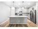 Modern kitchen featuring gray cabinets, stainless steel appliances and a center island with granite countertop at 3188 Via Da Vinci, Henderson, NV 89044