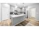 Modern kitchen with stainless steel appliances, gray cabinets, and granite countertops at 3188 Via Da Vinci, Henderson, NV 89044