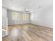 Spacious living room with wood flooring, neutral walls, and plantation shutters, offering ample natural light at 3188 Via Da Vinci, Henderson, NV 89044