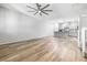 Bright open-concept living space with wood flooring and recessed lighting leading to the kitchen at 3188 Via Da Vinci, Henderson, NV 89044