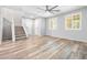 Cozy living room with natural light, wood flooring and a staircase leading to the upper level at 3188 Via Da Vinci, Henderson, NV 89044