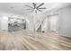 Open-concept living area featuring wood floors, staircase and seamless flow into the modern kitchen at 3188 Via Da Vinci, Henderson, NV 89044