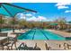 Community swimming pool with lounge chairs and shaded seating areas at 3188 Via Da Vinci, Henderson, NV 89044