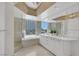 Modern bathroom with tub, walk-in shower, dual sinks and a large window at 322 Karen Ave # 308, Las Vegas, NV 89109