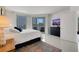 Bright bedroom features balcony access and a TV above a black dresser at 322 Karen Ave # 308, Las Vegas, NV 89109