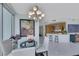 Dining area with glass table and chandelier adjacent to the kitchen, bathed in natural light at 322 Karen Ave # 308, Las Vegas, NV 89109