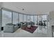 Bright living room with curved window wall and modern furniture arrangement at 322 Karen Ave # 308, Las Vegas, NV 89109