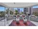 Bright living room with floor to ceiling windows showing palm trees and a city view at 322 Karen Ave # 308, Las Vegas, NV 89109
