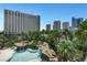 Enjoy rock features and a waterfall while swimming in the rock-lagoon style pool at 322 Karen Ave # 308, Las Vegas, NV 89109