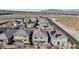 Aerial view showcases community homes, solar panels, landscaping, and pool in backyard at 340 Autumn Palace Ct, Las Vegas, NV 89144