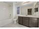 Bright bathroom with tiled floor, tub and shower, single sink vanity, and natural light from a window at 340 Autumn Palace Ct, Las Vegas, NV 89144