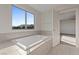 Light-filled bathroom with mountain views from the tub window at 340 Autumn Palace Ct, Las Vegas, NV 89144