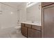 Bathroom features a single sink vanity, a shower-tub combo with white tile, and large mirror at 340 Autumn Palace Ct, Las Vegas, NV 89144