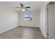 Bright bedroom features modern gray flooring, a ceiling fan, and a window for natural light at 340 Autumn Palace Ct, Las Vegas, NV 89144