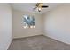Bright bedroom featuring a ceiling fan and a large window at 340 Autumn Palace Ct, Las Vegas, NV 89144