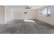 Large carpeted bonus room features a ceiling fan, bright window, and ample space for entertaining or relaxation at 340 Autumn Palace Ct, Las Vegas, NV 89144