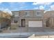 Charming two-story home featuring a two-car garage, stone accents, neutral paint, and a well-maintained front yard at 340 Autumn Palace Ct, Las Vegas, NV 89144