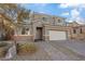 Charming two-story home featuring a two-car garage, stone accents, neutral paint, and a well-maintained front yard at 340 Autumn Palace Ct, Las Vegas, NV 89144