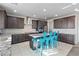 Well-equipped kitchen with stainless appliances, gray cabinets, granite counters, and island seating at 340 Autumn Palace Ct, Las Vegas, NV 89144