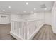 Bright upstairs loft area with wood floors, white railings, and multiple entryways at 340 Autumn Palace Ct, Las Vegas, NV 89144