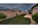 Large backyard featuring artificial turf, desert landscaping, and block wall for privacy at 3426 Side Saddle Ct, North Las Vegas, NV 89032