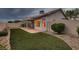 Well-maintained backyard featuring artificial turf, desert landscaping, and covered patio at 3426 Side Saddle Ct, North Las Vegas, NV 89032