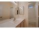 Bathroom featuring large mirror, white sink, vanity, and tile flooring with tub and shower at 3426 Side Saddle Ct, North Las Vegas, NV 89032