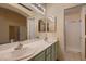 Bright bathroom featuring dual sinks, spacious counters, and a walk-in shower at 3426 Side Saddle Ct, North Las Vegas, NV 89032