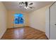 Cozy bedroom showcasing hardwood floors, a vaulted ceiling, and large window at 3426 Side Saddle Ct, North Las Vegas, NV 89032