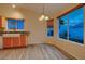Bright dining room with tile flooring and light wood cabinets at 3426 Side Saddle Ct, North Las Vegas, NV 89032