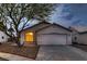 Inviting single-story home featuring a two-car garage and drought resistant landscaping at 3426 Side Saddle Ct, North Las Vegas, NV 89032