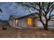 Charming single-story home with a well-manicured front yard and warm exterior lighting at dusk at 3426 Side Saddle Ct, North Las Vegas, NV 89032
