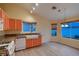 Charming kitchen featuring updated appliances and fixtures, granite countertops, and eat-in area with wood flooring at 3426 Side Saddle Ct, North Las Vegas, NV 89032