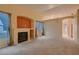 Spacious living room featuring a fireplace, neutral carpet, and light-filled windows at 3426 Side Saddle Ct, North Las Vegas, NV 89032
