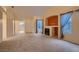 Large living room showcasing a fireplace, high ceilings, and openings to other rooms at 3426 Side Saddle Ct, North Las Vegas, NV 89032