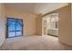 Spacious main bedroom featuring carpeting, a sliding glass door, a walk-in closet and an attached bathroom at 3426 Side Saddle Ct, North Las Vegas, NV 89032