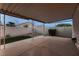 Covered patio with concrete tiles, small grass patch and decorative rock in the backyard at 3426 Side Saddle Ct, North Las Vegas, NV 89032