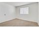 This carpeted bedroom has a neutral wall color and one window at 3455 Erva St # 112, Las Vegas, NV 89117