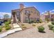 Two-story condo featuring well-maintained landscaping and exterior stairs to the upper-level units at 3455 Erva St # 112, Las Vegas, NV 89117